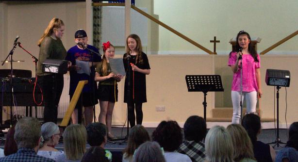 Young singers performing on stage at Summer Vibez