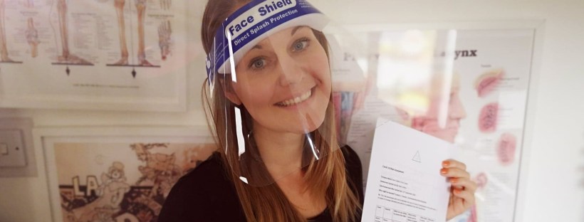 Kate in a visor with a risk assessment for singing lessons face to face in Cheshire